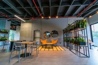 a room with tables and chairs and some plants at Luxury Suite in El Poblado Co-Work, Gym, Fast WiFi in Medellín