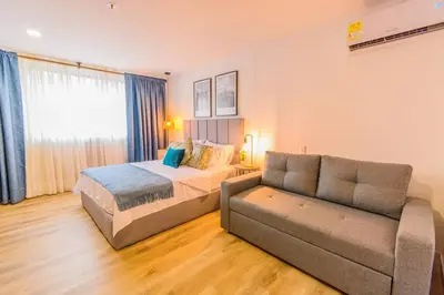 a bedroom with a bed and a couch at Luxury Suite in El Poblado Co-Work, Gym, Fast WiFi in Medellín