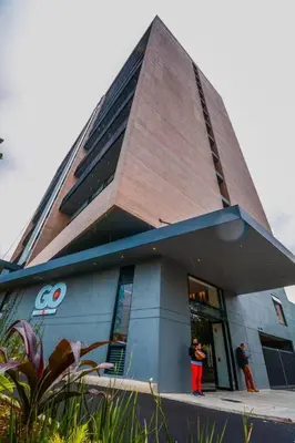 a building with two people standing outside of it at Luxury Suite in El Poblado Co-Work, Gym, Fast WiFi in Medellín