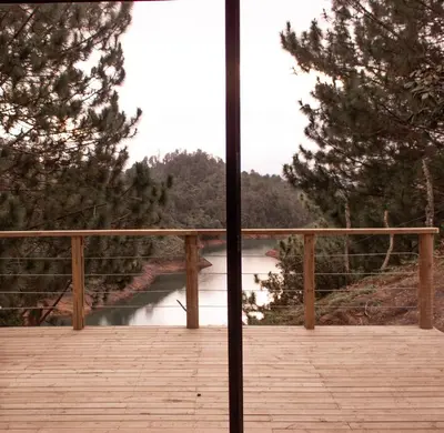 a view of a river from a wooden bridge at Cabañas Refugio Himalaya in Guatapé