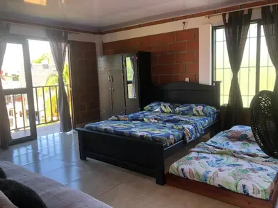 two beds in a room with windows at CASA EN DORADAL in Puerto Triunfo