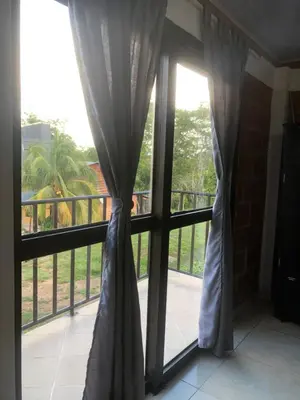 a window with a view of a balcony at CASA EN DORADAL in Puerto Triunfo