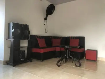 a black couch with red pillows and a table at CASA EN DORADAL in Puerto Triunfo