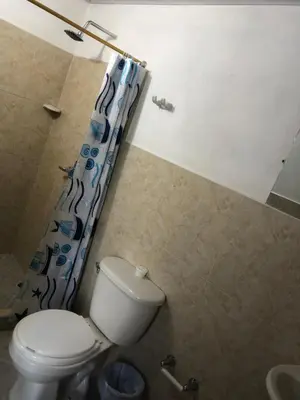 a bathroom with a toilet and a shower curtain at CASA EN DORADAL in Puerto Triunfo