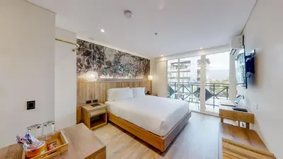 a bedroom with a white bed and a large window at Origen Hotel Boutique in Medellín