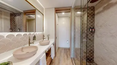 a bathroom with two sinks and a shower at Origen Hotel Boutique in Medellín