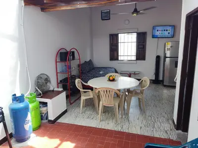a kitchen with a table and chairs in a room at Cabaña 52 en la Aldea Doradal Santorini Colombiano in Doradal