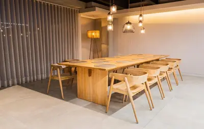 a long wooden table and chairs in a room at Topá House in Medellín