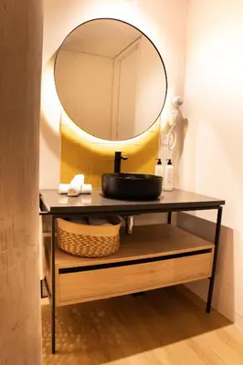 a bathroom vanity with a sink and a mirror at Topá House in Medellín