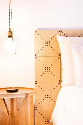a bedroom with a bed with a wooden headboard at Topá House in Medellín