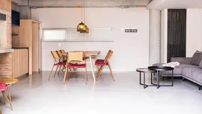 a living room with a table and chairs and a couch at Topá House in Medellín