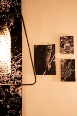 two pictures on a wall next to a lamp at Topá House in Medellín