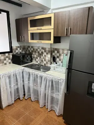 a kitchen with a table with a white table cloth on it at APARTAMENTO CON VISTA A LAS MONTAÑAS CAPACIDAD 6 PERSONAS SECTOR VILLAMARIA in Villamaría