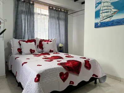 a bedroom with a bed with red hearts on it at APARTAMENTO CON VISTA A LAS MONTAÑAS CAPACIDAD 6 PERSONAS SECTOR VILLAMARIA in Villamaría