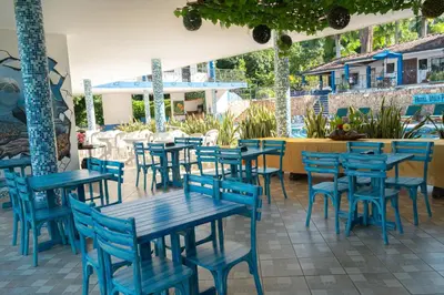a group of blue tables and chairs on a patio at Hotel Villa Alicia in San Jerónimo