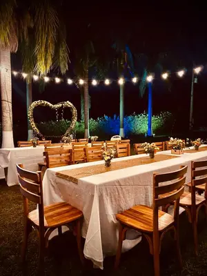 a long table with chairs and lights at a wedding at Hotel Villa Alicia in San Jerónimo