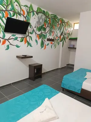 a room with a bed and a painting on the wall at Hotel Villa Alicia in San Jerónimo