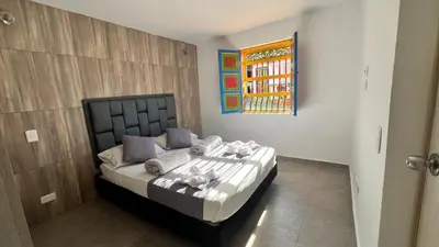 a bedroom with a bed in a room at Apto Moderno, Ubicacion Perfecta, a media calle del Malecon y Embalse, a 8 min de la Piedra del Peñol in Guatapé