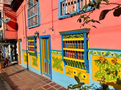 a colorful building with colorful doors and windows at Apto Moderno, Ubicacion Perfecta, a media calle del Malecon y Embalse, a 8 min de la Piedra del Peñol in Guatapé