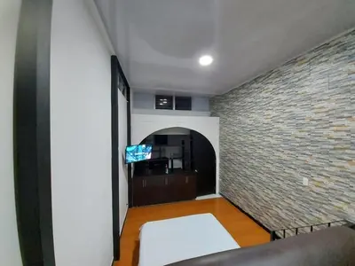 a living room with a brick wall and a couch at Apartaestudio2 Sector Cable-Estadio in Manizales
