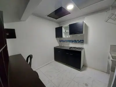 a small kitchen with a stove and a sink at Apartaestudio2 Sector Cable-Estadio in Manizales