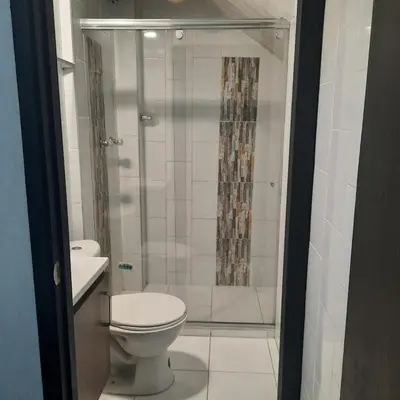 a bathroom with a toilet and a shower at Apartaestudio2 Sector Cable-Estadio in Manizales