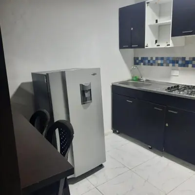 a kitchen with a stainless steel refrigerator and black cabinets at Apartaestudio2 Sector Cable-Estadio in Manizales