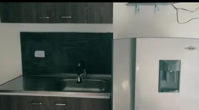 a kitchen with a sink and a refrigerator at Apartamento vacacional en Medellín central privado y tranquilo in Medellín