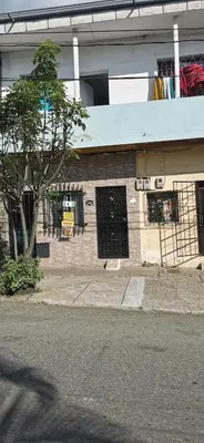a brick building with black doors and a tree at Apartamento vacacional en Medellín central privado y tranquilo in Medellín