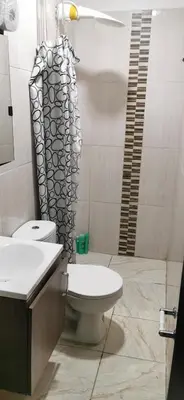 a bathroom with a toilet and a sink at Apartamento vacacional en Medellín central privado y tranquilo in Medellín