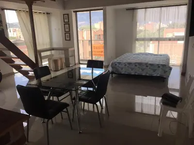 a room with a table and chairs and a bed at Apartamento Lof, Dúplex, iluminado, bueno , céntrico y bien ubicado en Laureles estadio in Medellín