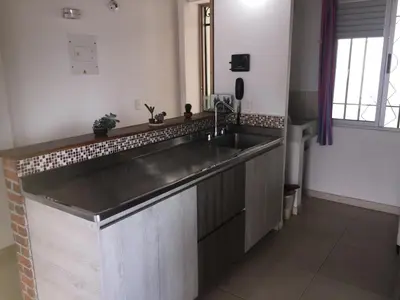a kitchen with a large stainless steel sink at Apartamento Lof, Dúplex, iluminado, bueno , céntrico y bien ubicado en Laureles estadio in Medellín