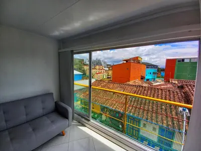 a room with a window with a view of a city at Apartamento Centro Guatapé, parque y embalse in Guatapé