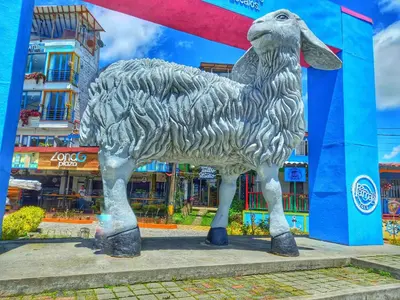 a statue of a sheep in front of a building at Apartamento Centro Guatapé, parque y embalse in Guatapé