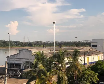 a view of a parking lot with a bridge in the background at HOTEL DORADO PUERTO BERRIO in Puerto Berrío