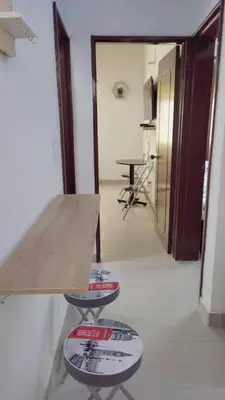 a room with a counter and a table and a hallway at AMPLIO APARTAMENTO AMOBLADO SECTOR LAURELES-ESTADIO Paris in Medellín