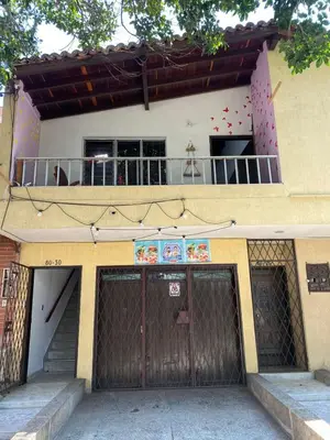a building with two garage doors and a balcony at Hostel Urban City Medellin in Medellín