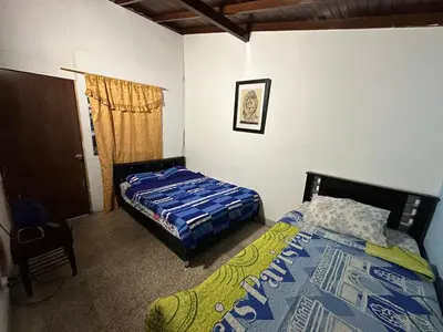 a bedroom with two beds and a window at Hostel Urban City Medellin in Medellín