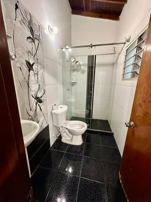 a bathroom with a toilet and a sink at Hostel Urban City Medellin in Medellín