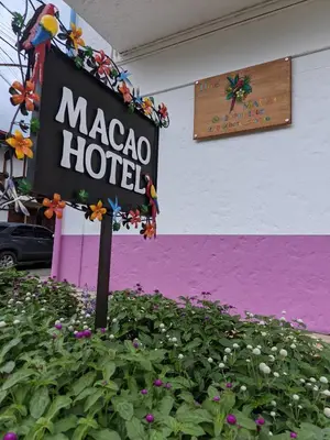 a sign for a macaca hotel in a flower garden at Hotel Macao in Jardin