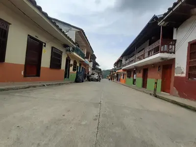 an empty street in a town with buildings at Hostal La Comedia in Jardin