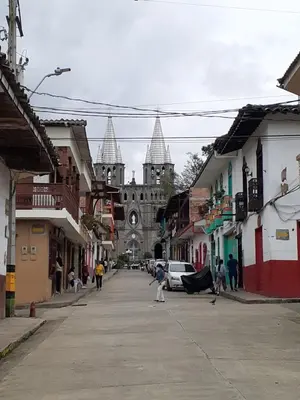 a city street with a church in the background at Hostal La Comedia in Jardin