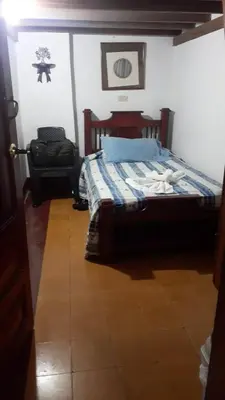 a bedroom with a bed in a room at Hostal La Comedia in Jardin