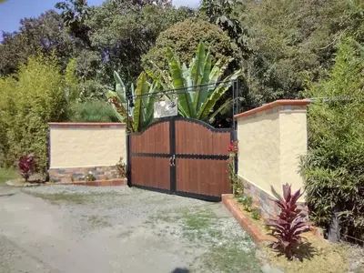 a wooden fence with a gate in a yard at La Cabaña de Huckleberry in El Retiro