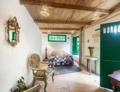 a bedroom with a bed and a table and chairs at Finca Los Abuelos - La Planta in Concepción