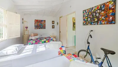 a room with a bed and a bike in it at Finca Los Abuelos - La Planta in Concepción