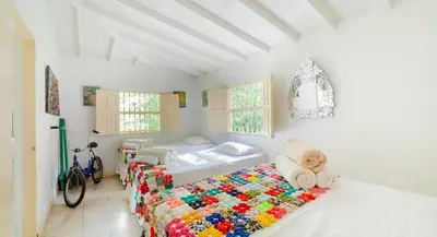a bedroom with two beds with a quilt at Finca Los Abuelos - La Planta in Concepción