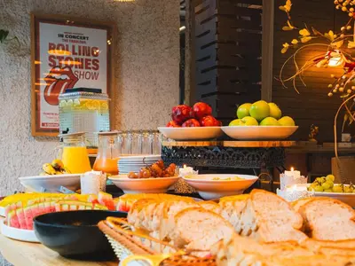 a buffet of food with bread and fruit on a table at Hashtag 98 Hotel By Jalo in Medellín