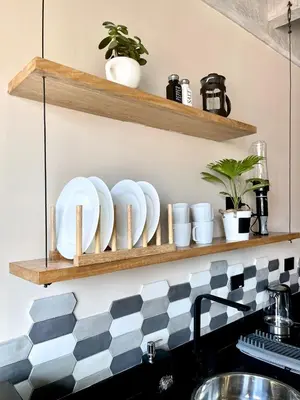 a shelf above a kitchen counter with dishes on it at Beminimal Hotel in Medellín
