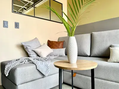 a living room with a couch and a vase on a table at Beminimal Hotel in Medellín
